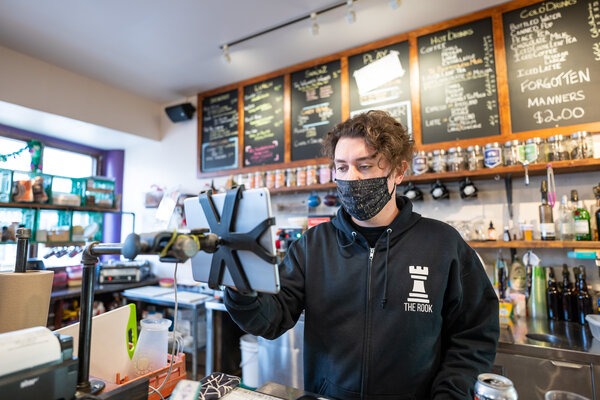 Kyle Kornic, founder of The Rook, works the checkout at his other business, Brew Wizards