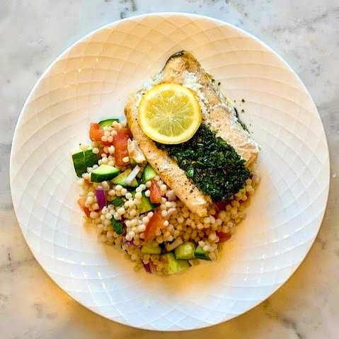 Close of up lake trout entrée with chimichurri.