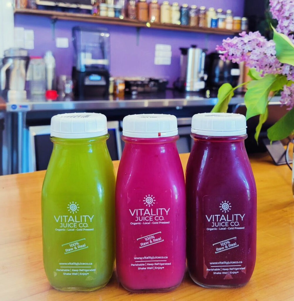 Three colourful bottles of freshly pressed juice.