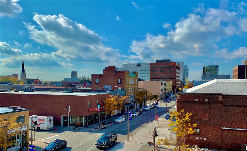 Downtown Oshawa from a rooftop view with a bright blue sky.