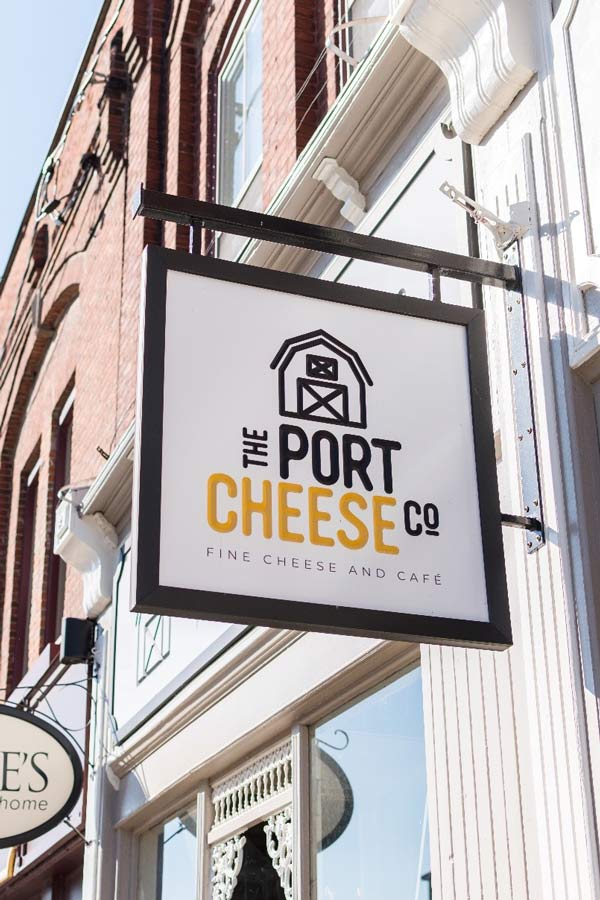 Hanging sign outside of Port Cheese.