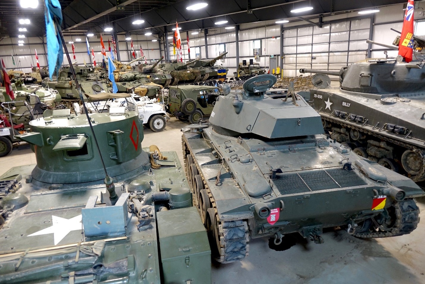 A room full of tanks and old military vehicles.