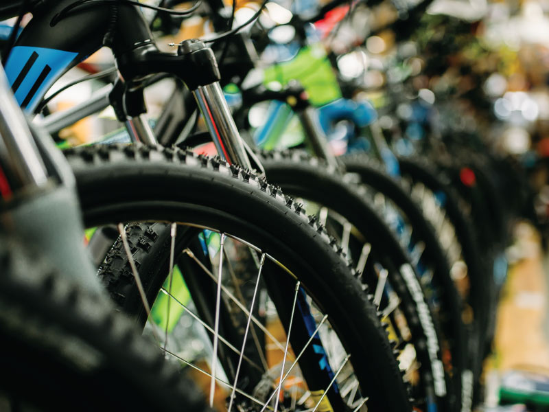 Close up of a row of bicycles in-store.