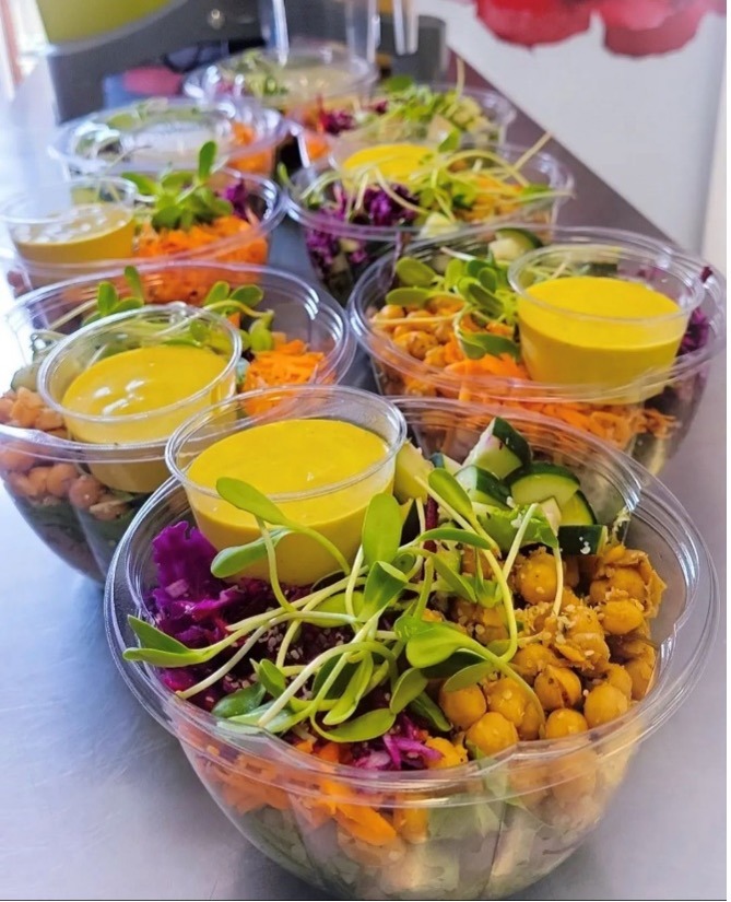 A row of rainbow salad bowls from Vitality Juice Co.
