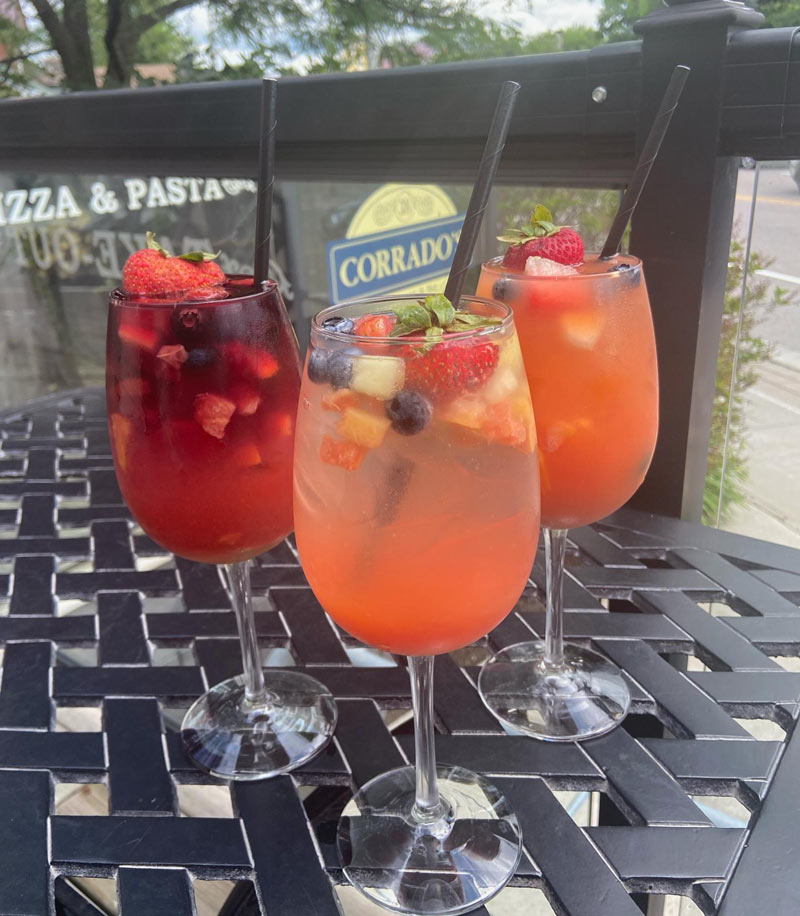 Three cocktails on a patio table at Corrado's.