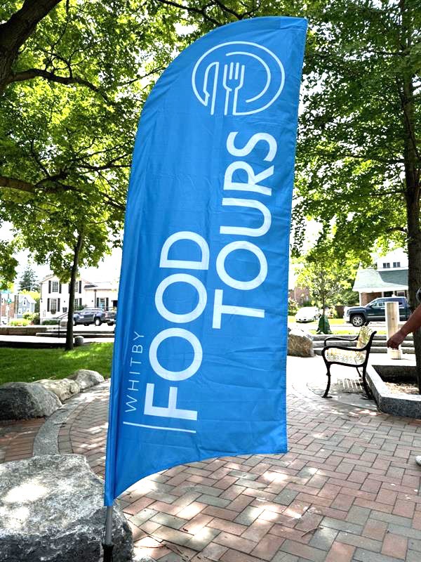 Whitby Food Tour banner at a park.